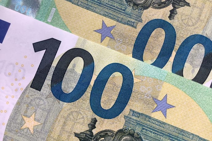 Detailed view of overlapping 100 Euro banknotes showcasing intricate design details.