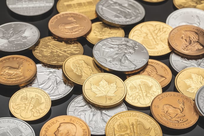 A detailed view of various gold and silver coins, ideal for financial themes.