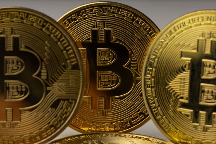 Detailed view of golden bitcoin coins, symbolizing digital currency and blockchain technology.