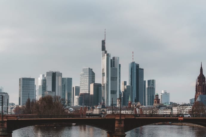 Explore the iconic skyline of Frankfurt featuring modern skyscrapers and historic landmarks over the Main River.