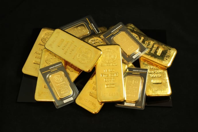 A collection of precious gold bars stacked elegantly, symbolizing wealth and prosperity.