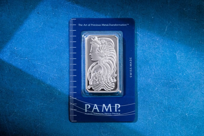 Silver bar against a striking blue background symbolizes wealth and value.