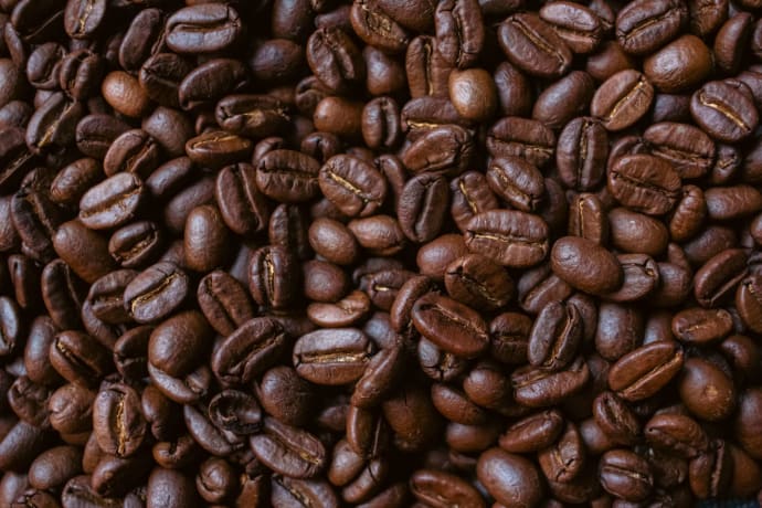 Closeup of aromatic roasted coffee beans showcasing rich textures and deep brown hues.