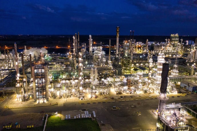 Aerial view of a brightly lit industrial refinery at night in Rosemount, MN.