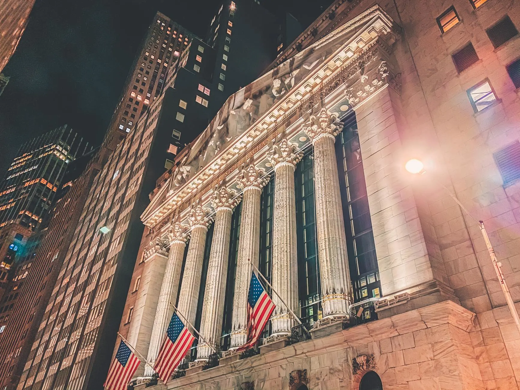 A striking night view of the New York Stock Exchange's illuminated facade in Manhattan.