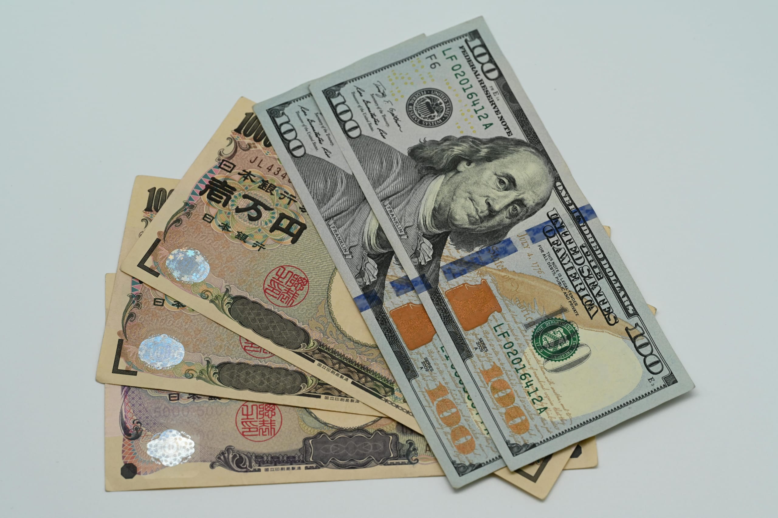 Close-up image of US dollars and Japanese yen notes, representing currency exchange concept.