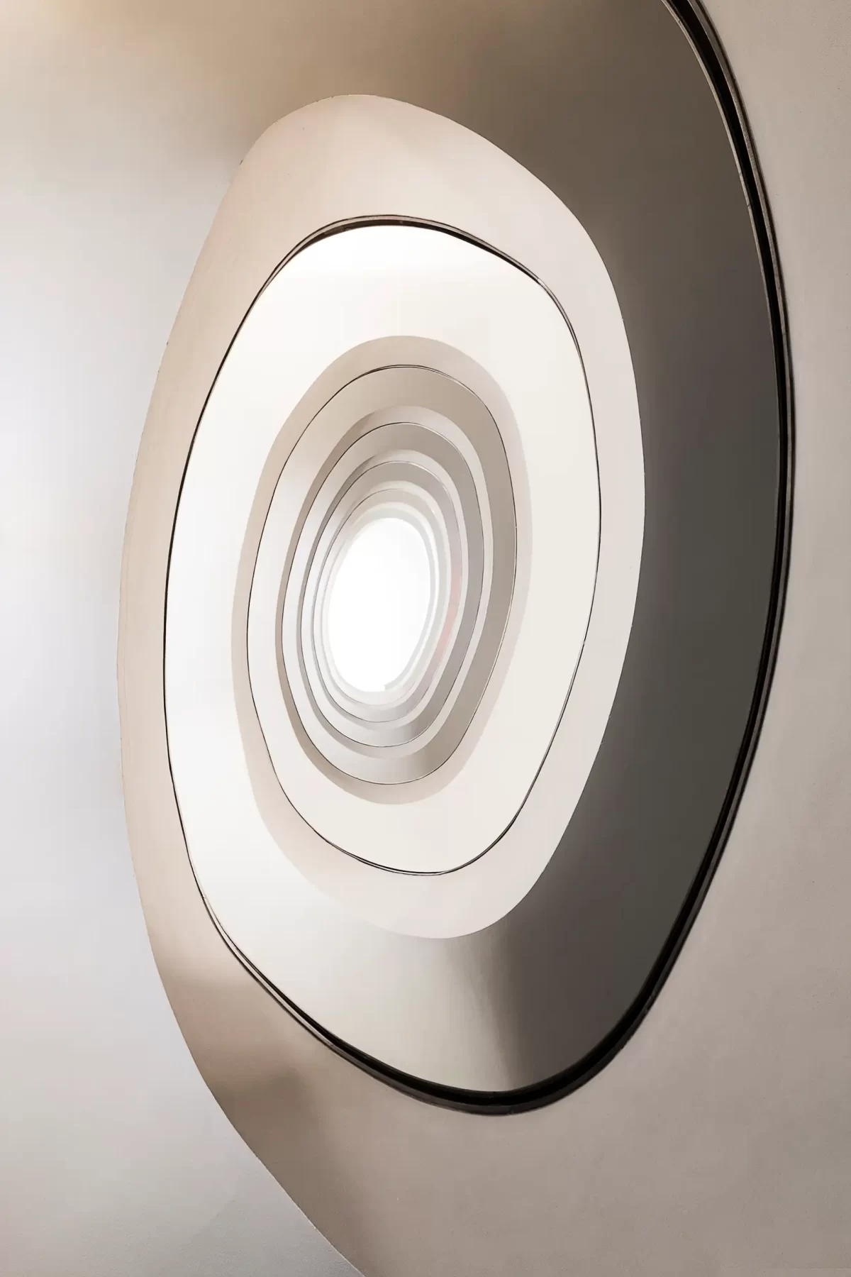 Fine art architecture photography of almost infinity consists of a look-up at Porto's minimalistic, white spiral staircase.