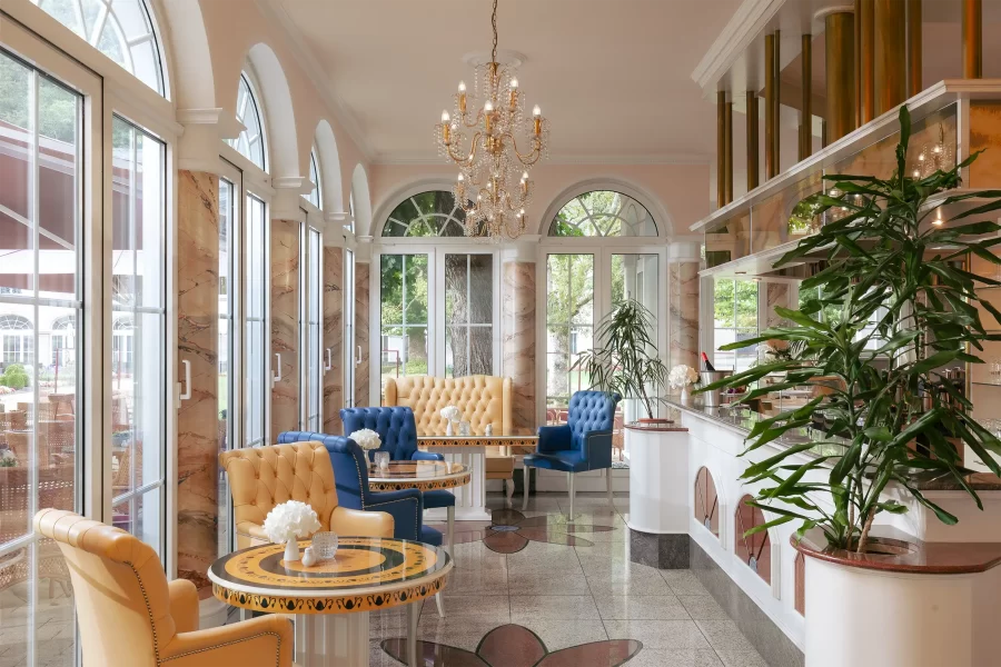 Heller Café- und Barbereich im Hotel Fürstenhof Bad Bertrich mit Sitzgelegenheiten und Blick in den Spa-Garten.