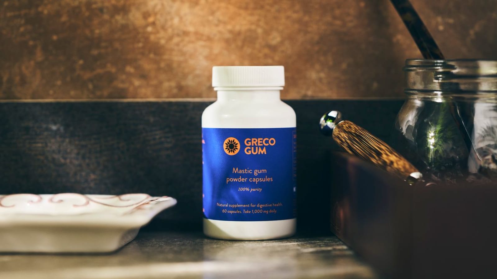 Greco Gum mastic powder capsules on counter.