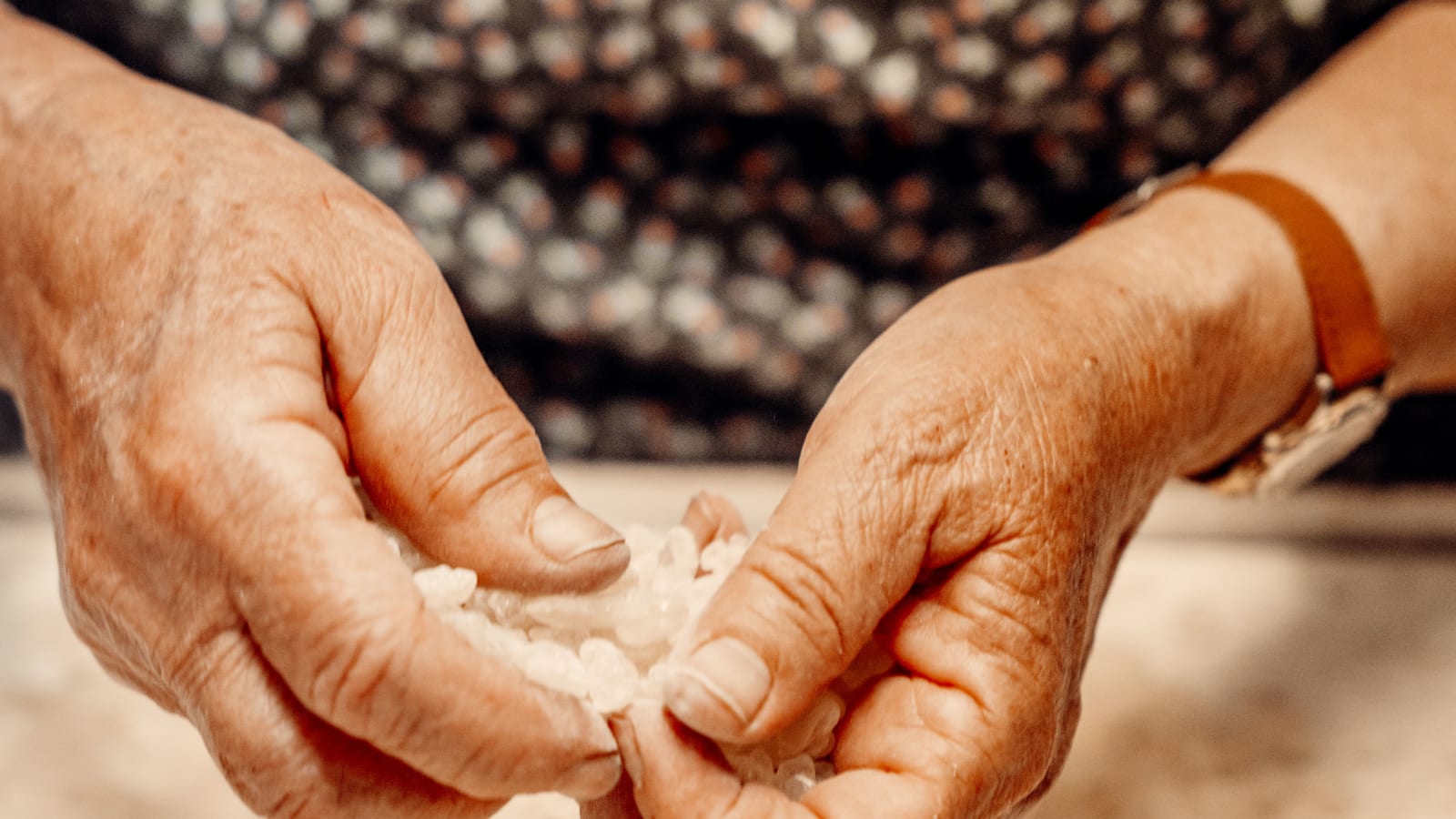 Lady sorting mastic nuggets and droplets.