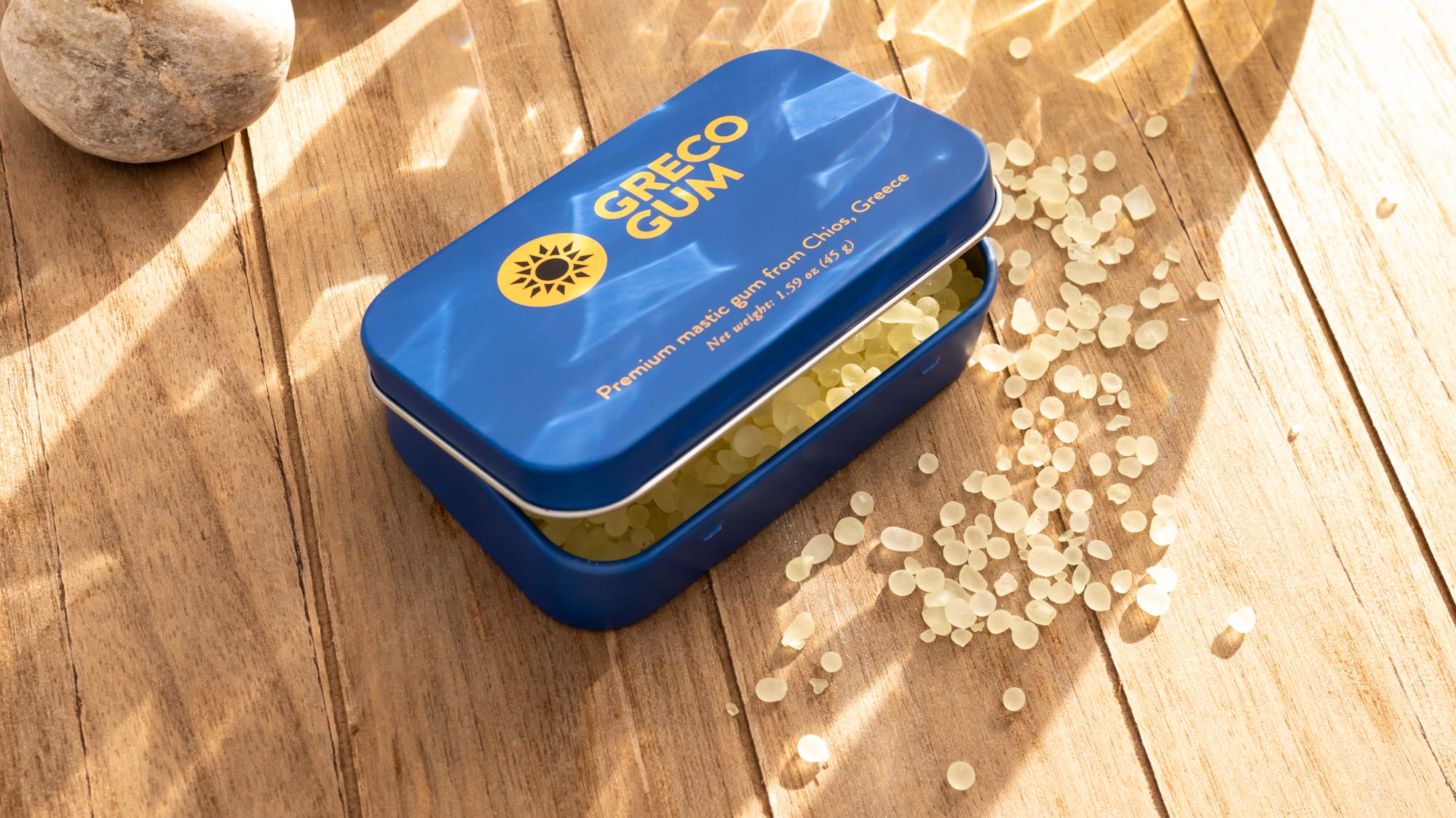 Tin of mastic gum in natural lighting.
