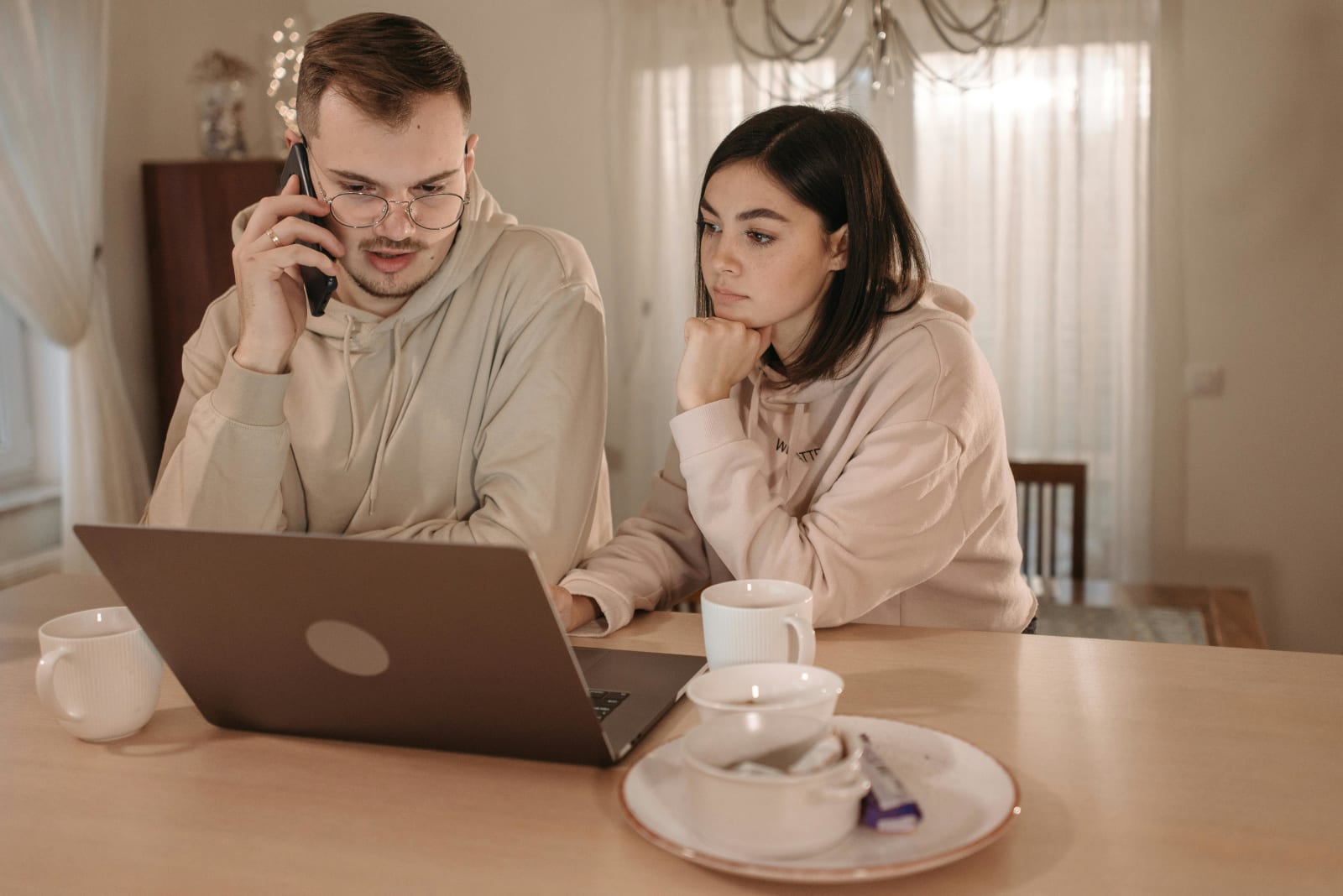 A couple looks skeptically at their computer