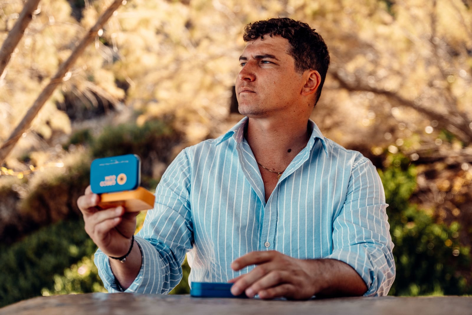 Man wearing blue shirt holding Greco Gum