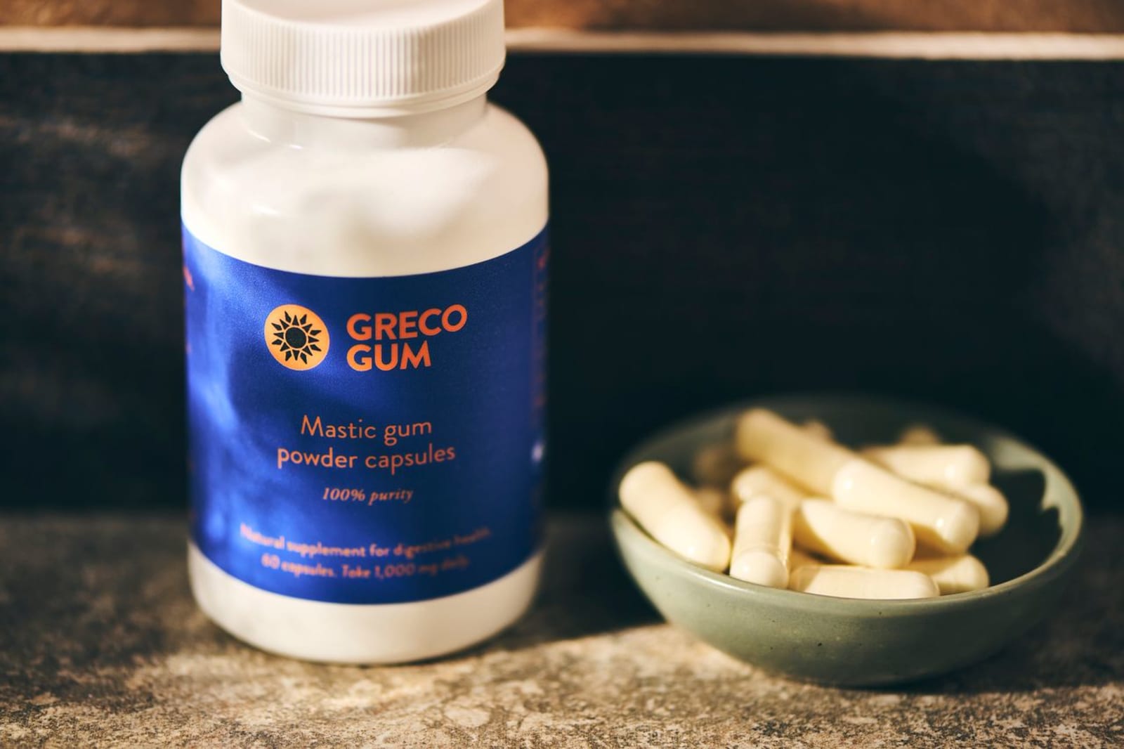 A bottle and bowl of mastic gum powder capsules