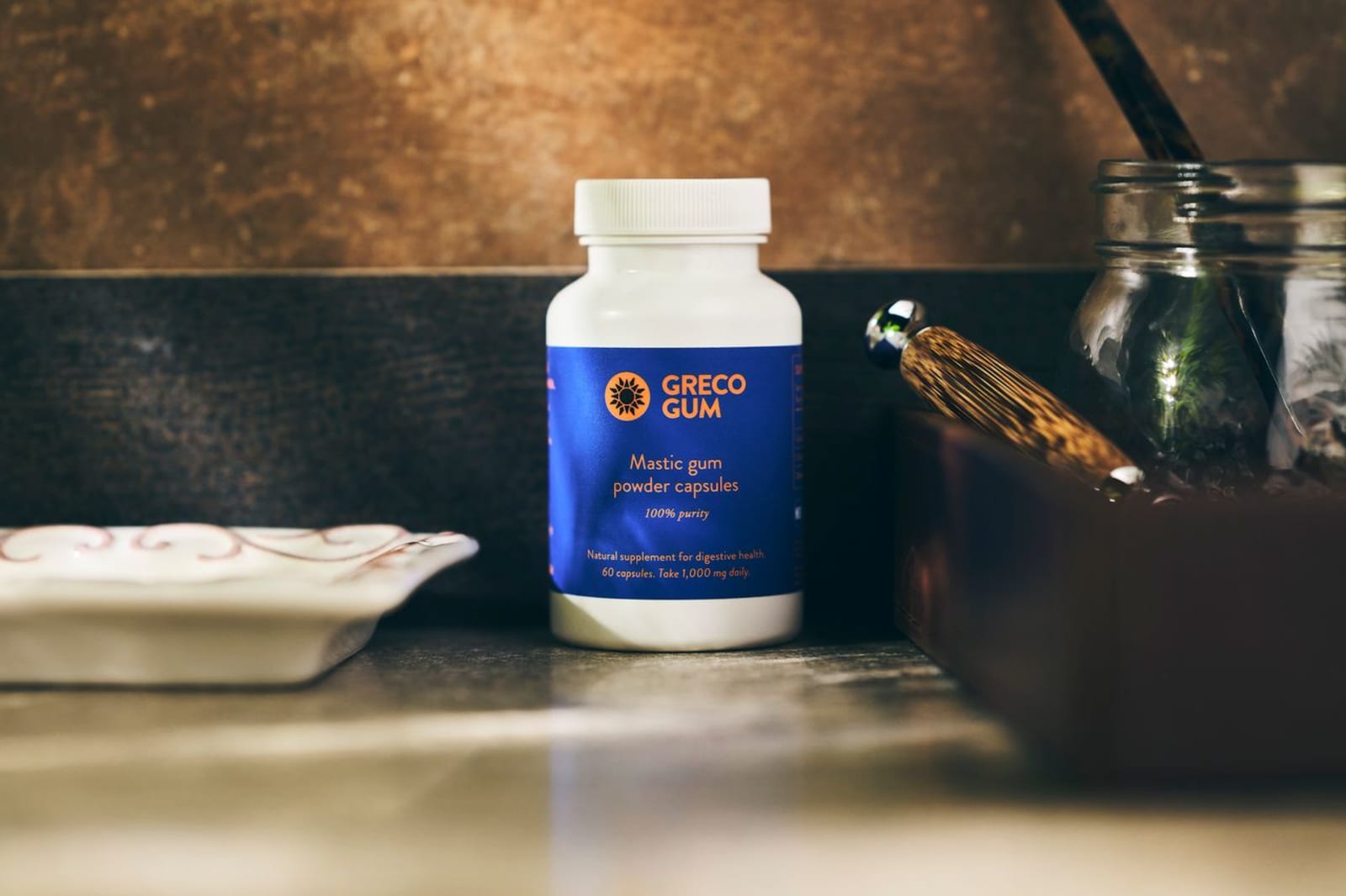 Greco Gum mastic powder capsules on counter.