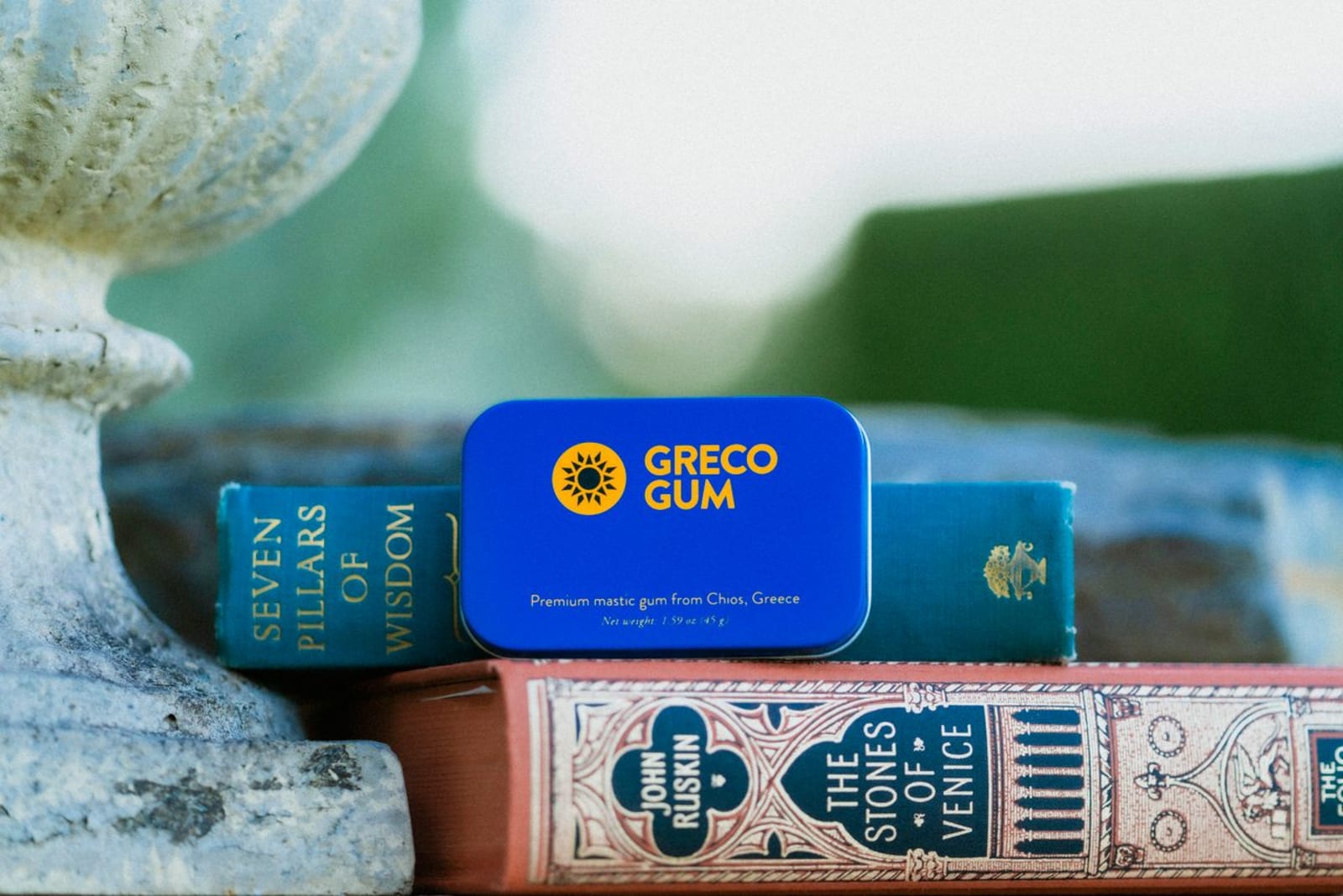 Mastic gum tin with two books.