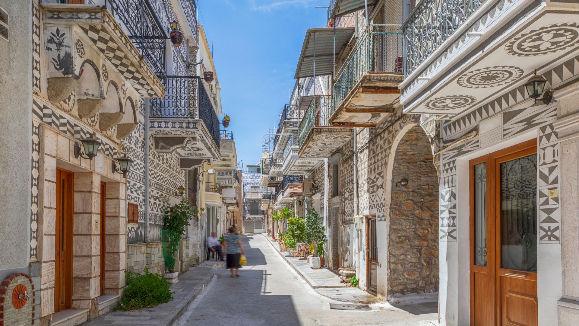 Photo of street in Pyrgi, Chios, featuring its iconic building style.