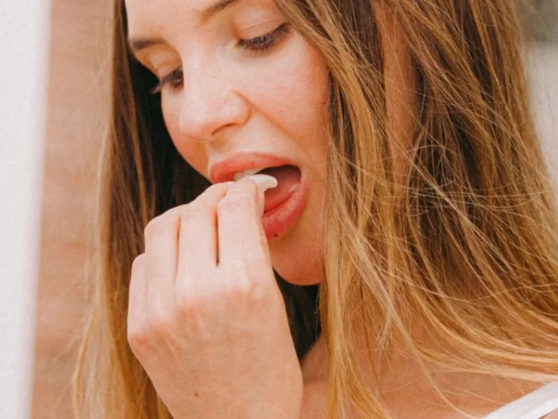 A woman tasting a piece of Greco mastic gum