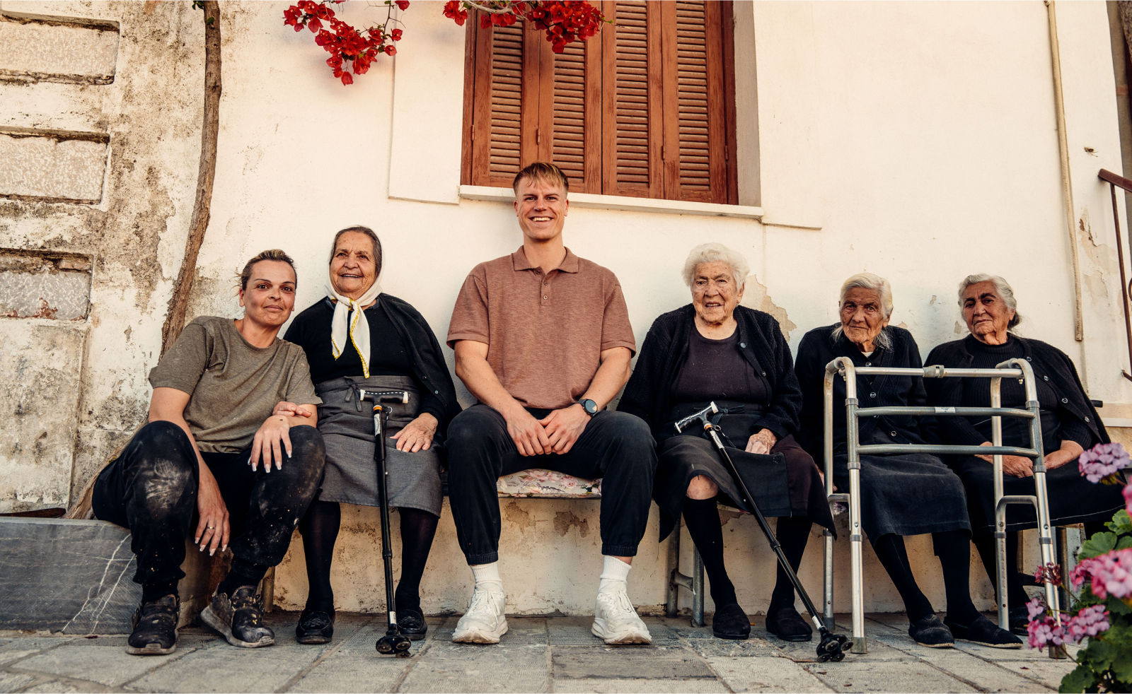 Friend of the brand Marcel with local grandmothers in a mastic village on Chios