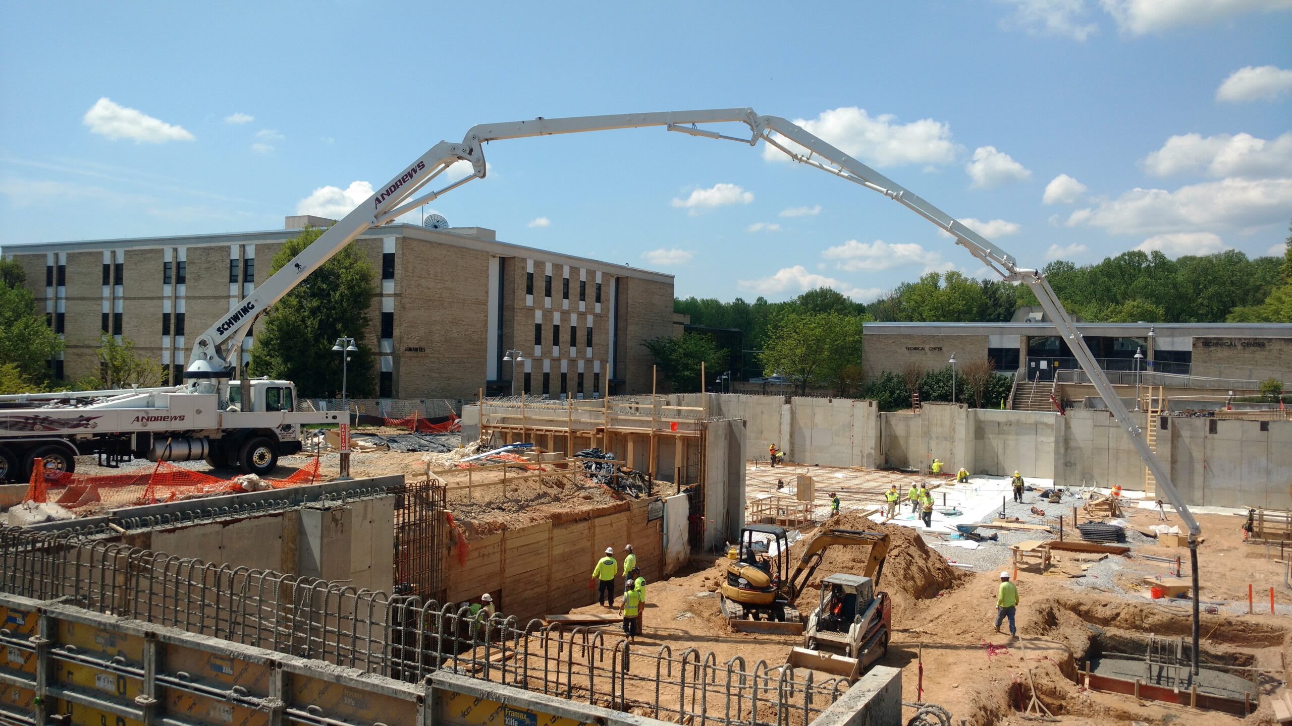 Andrews concrete boom pump truck working at a construction site in West Virginia.