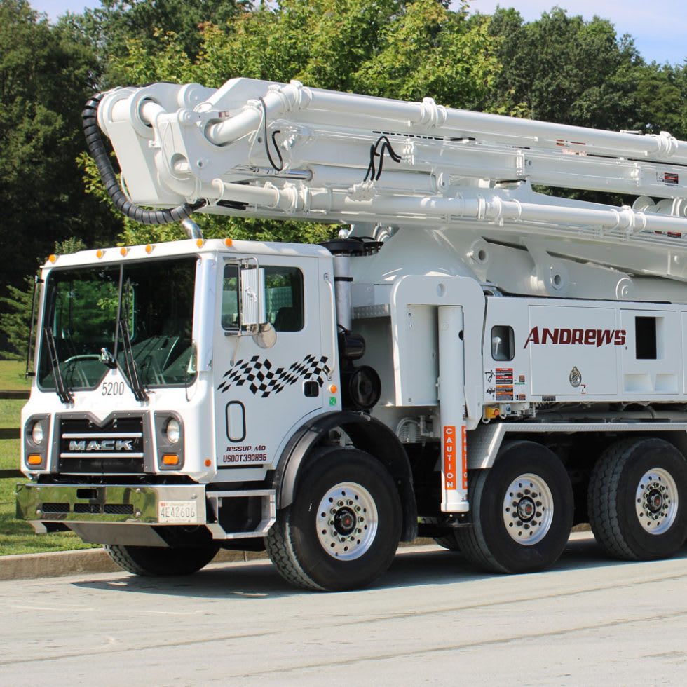 Close-up of a white Mack concrete boom pump truck in West Virginia.