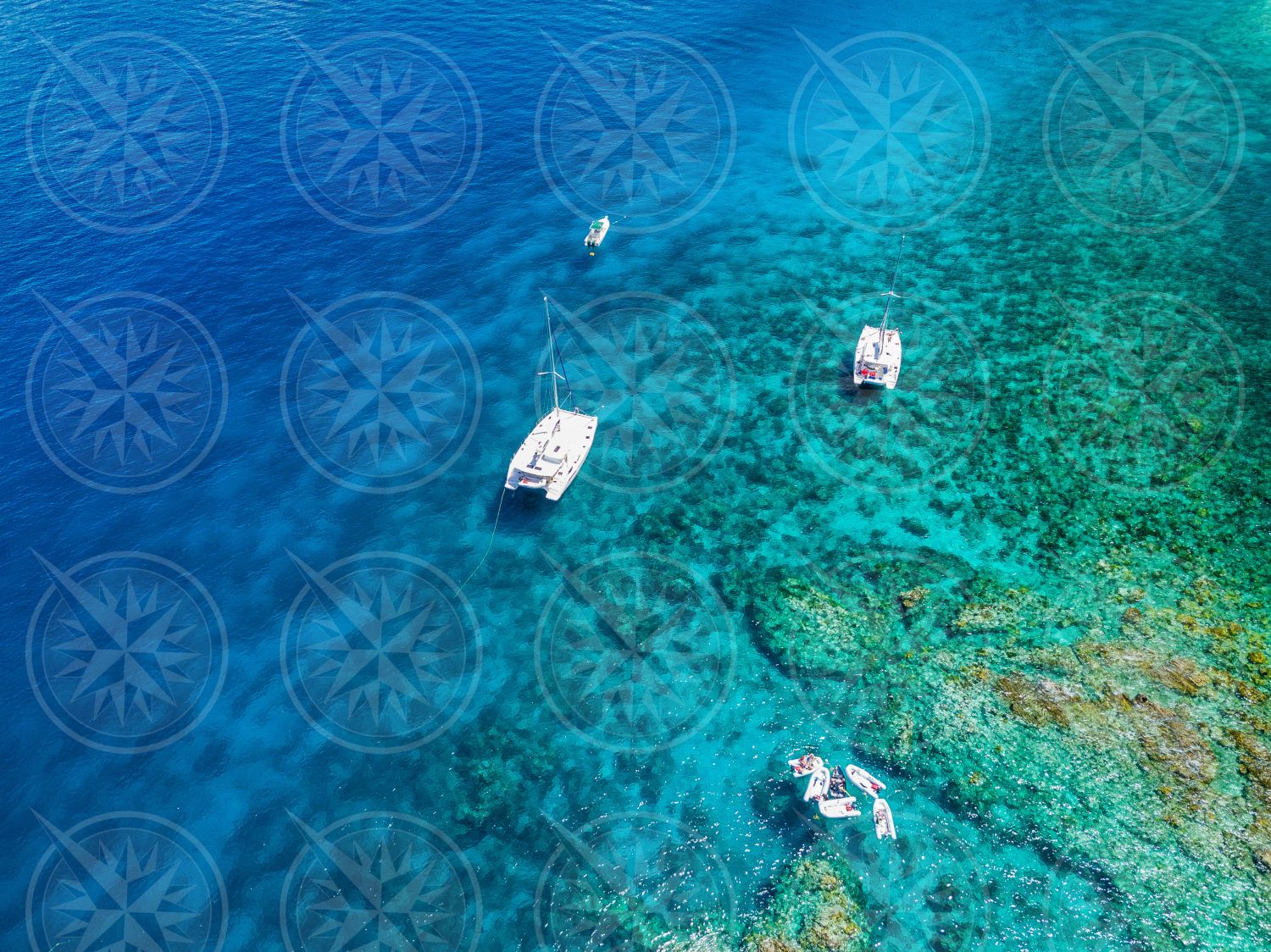 Boats in clear water from above