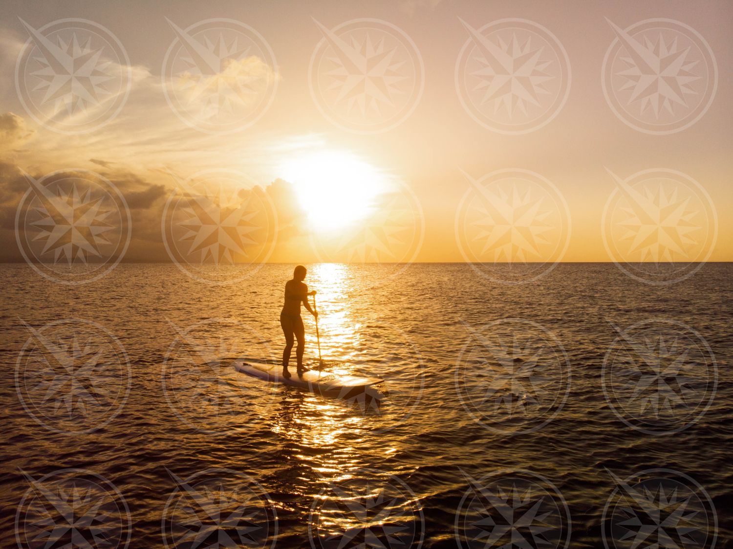 Stand up paddle boarding at sunset