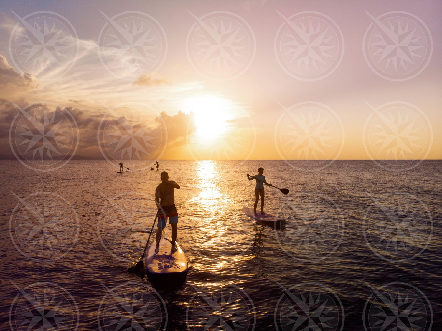 Stand up paddle boarding at sunset