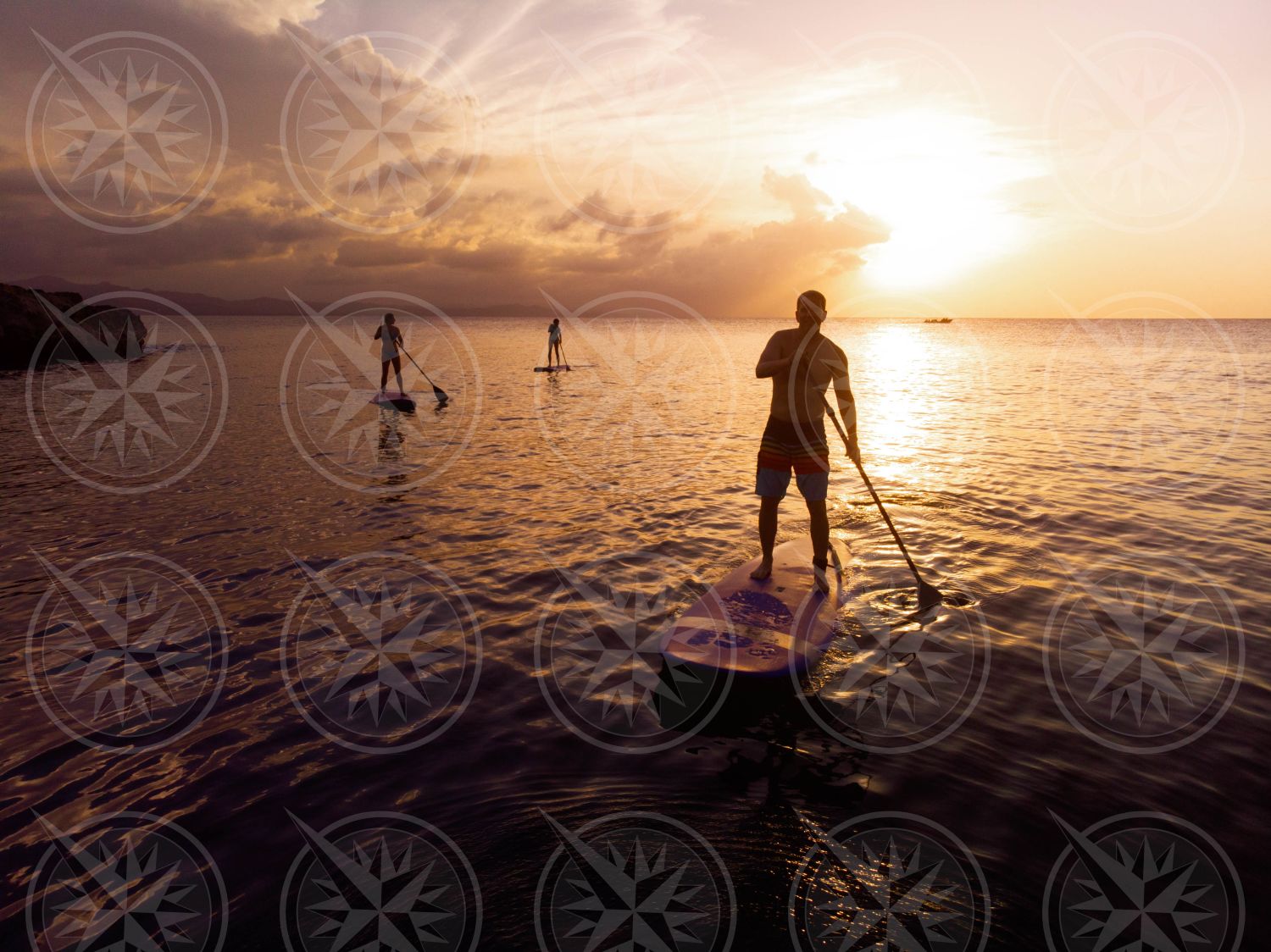 Stand up paddle boarding at sunset