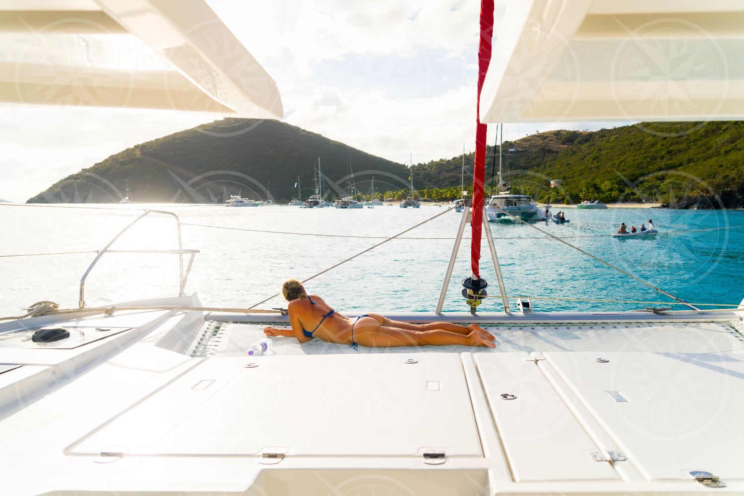 Woman in bikini on the bow of a catamaran off White Bay, Jost Van Dyke, British Virgin Islands