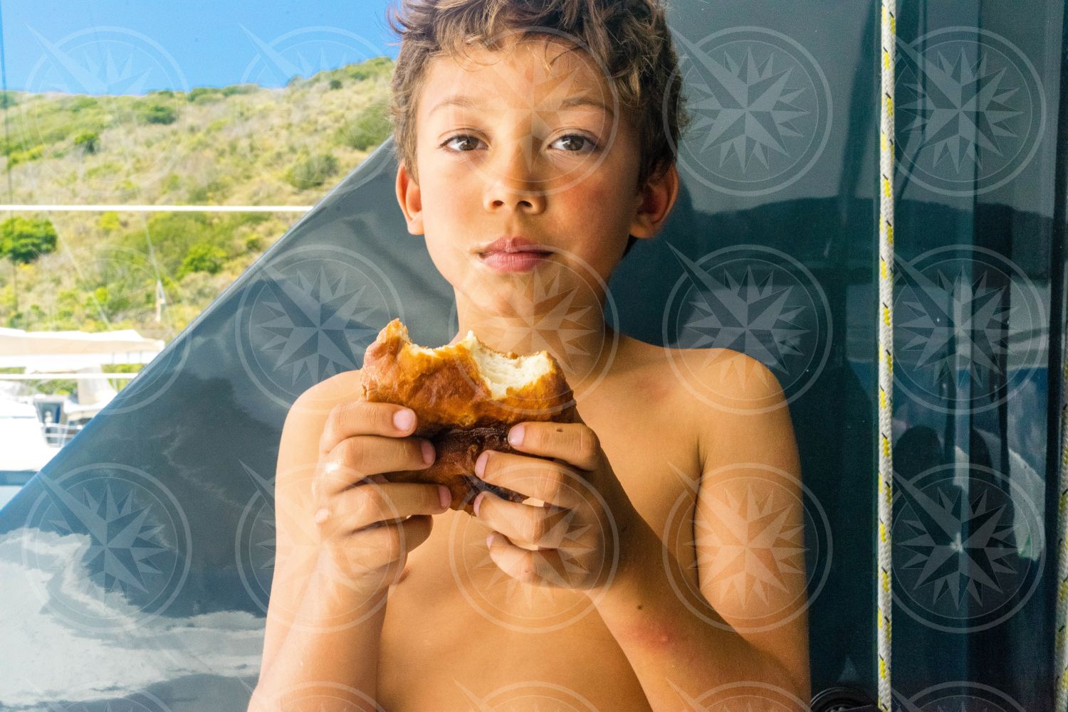 Young boy eating johnny cake