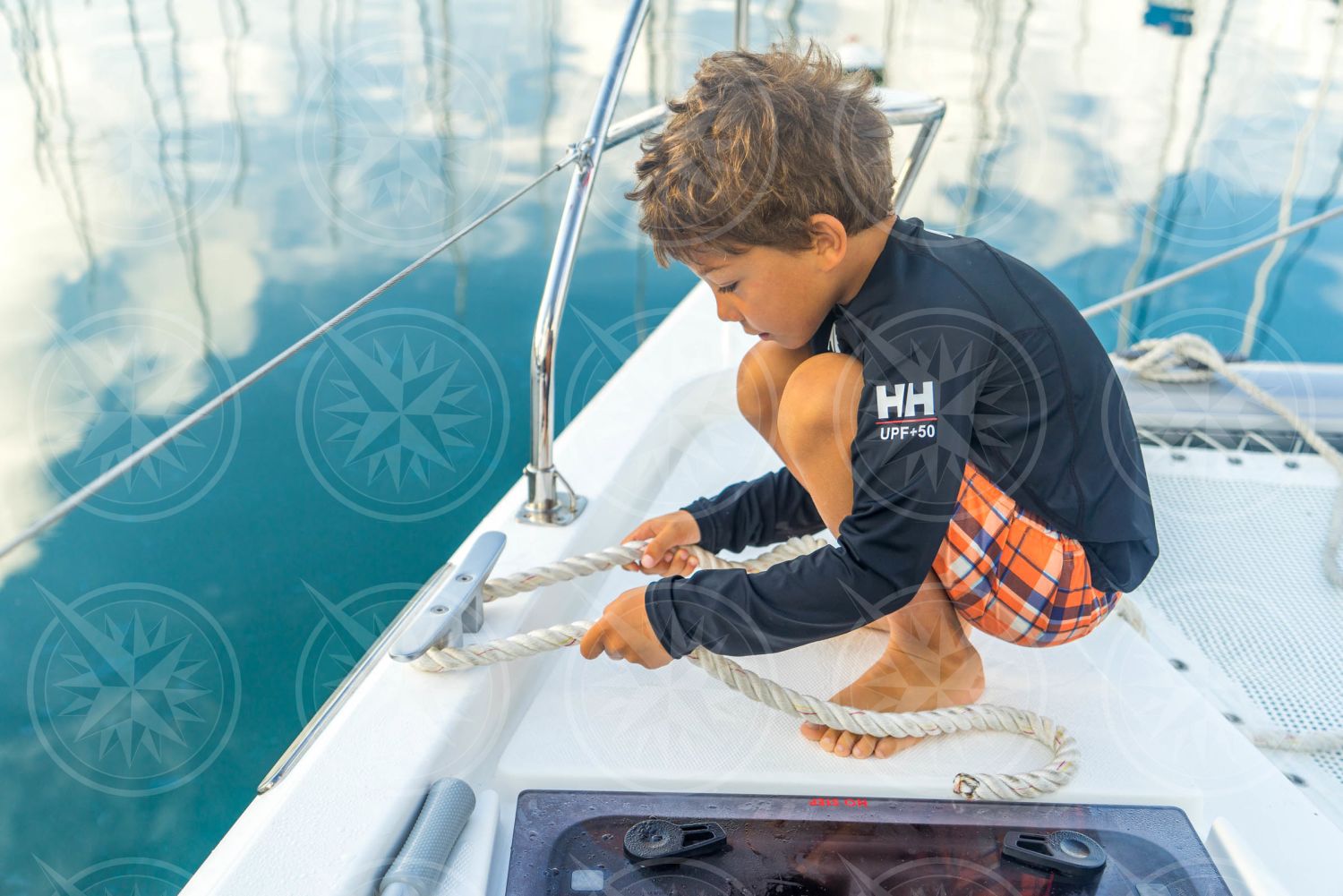 Young boy tying dock line