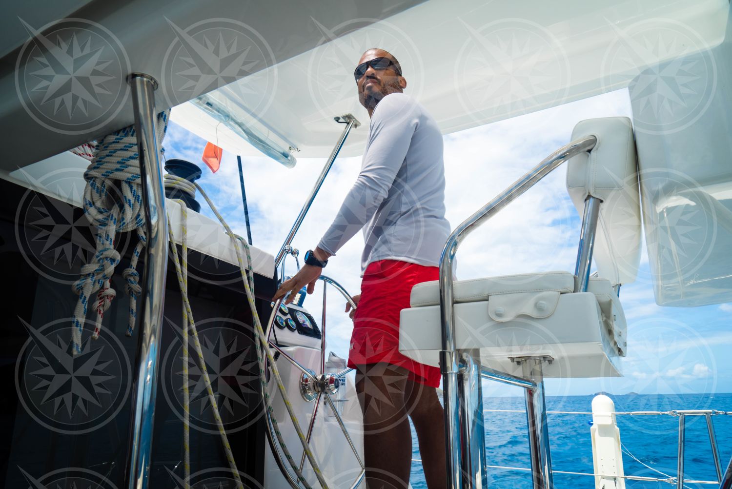 Man standing at sailboat helm