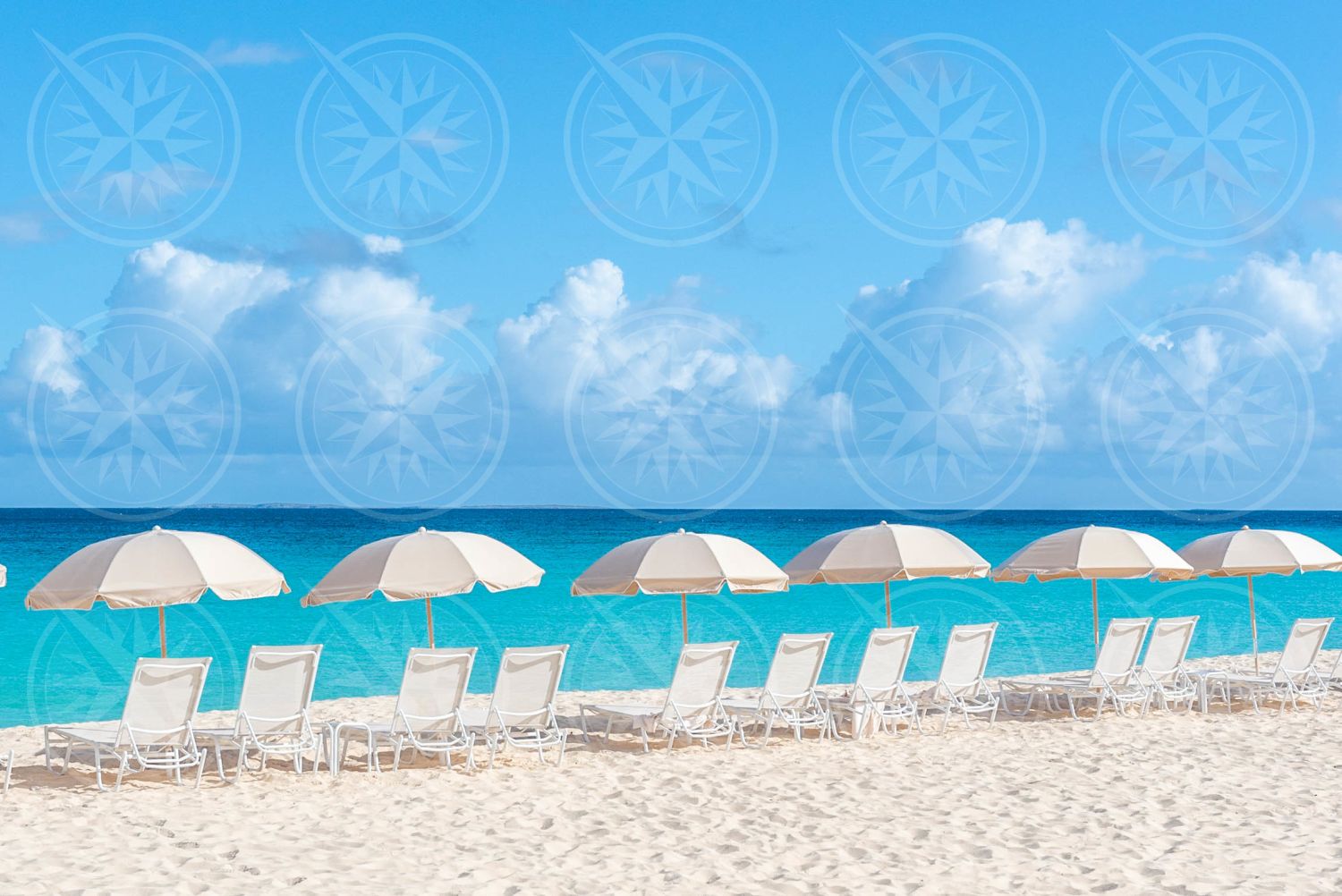 Line of umbrellas on white sand beach