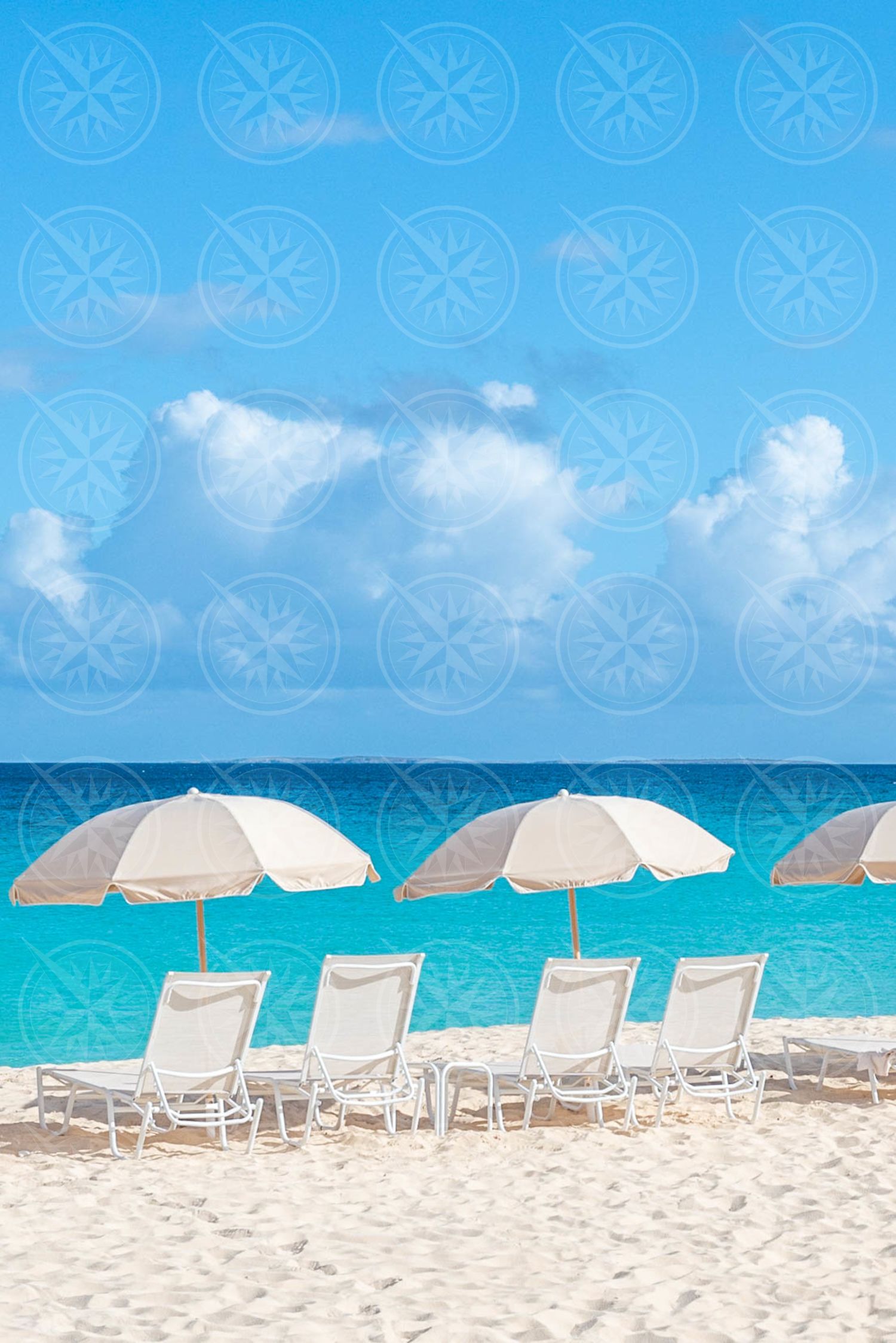 Line of umbrellas on white sand beach