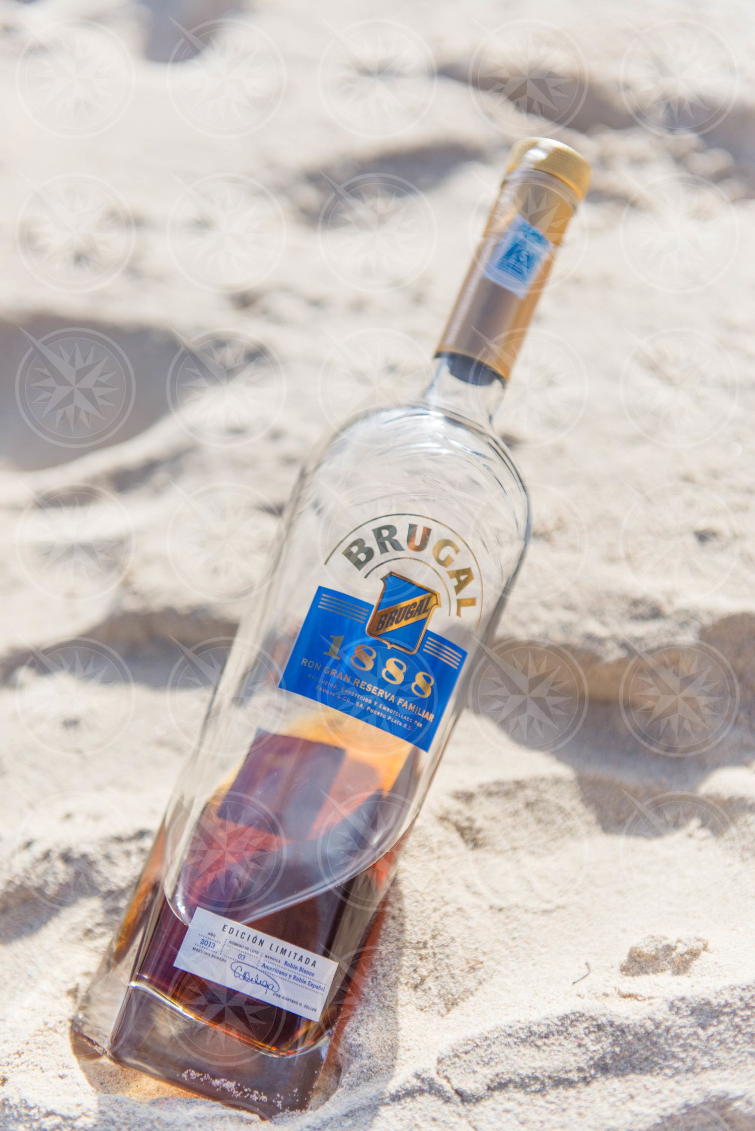 Bottle of rum in sand 2