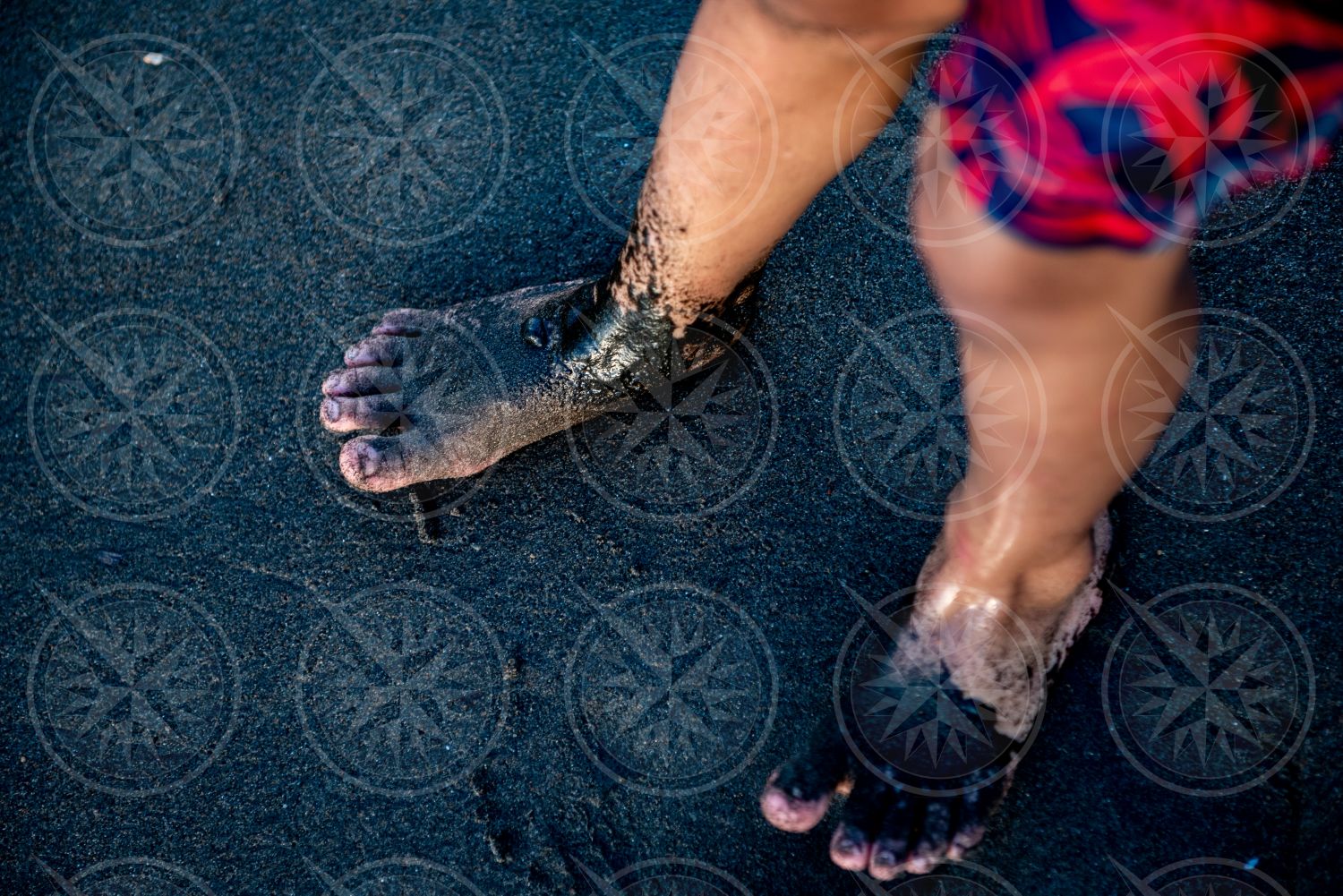 Boy on black sand beach