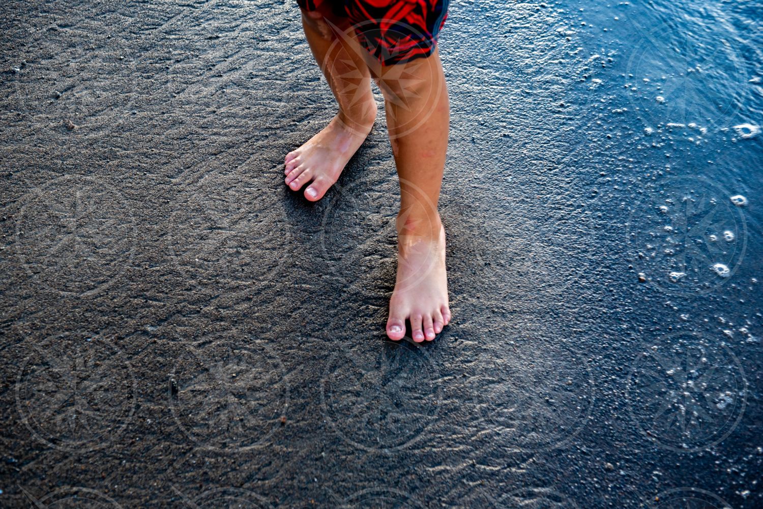 Boy on black sand beach 2