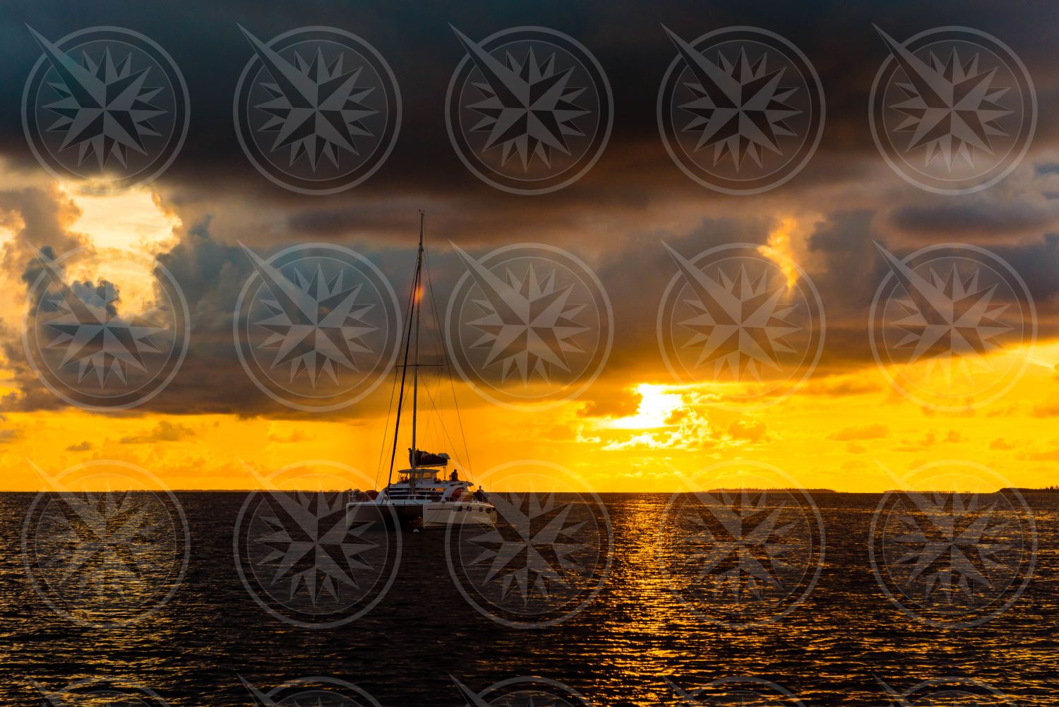 Sunset behind sailboat at sea