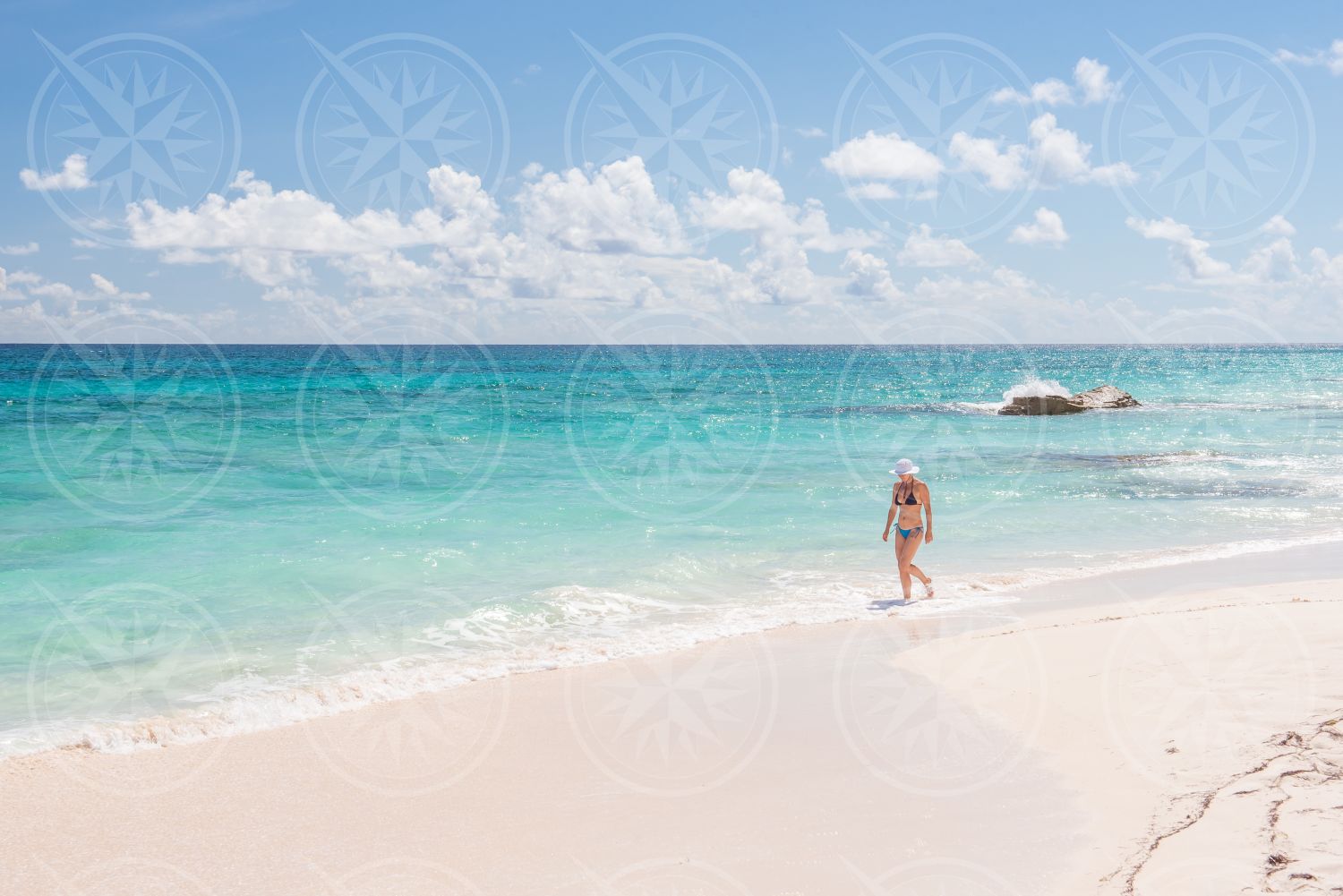 Woman in bikini on white sand beach