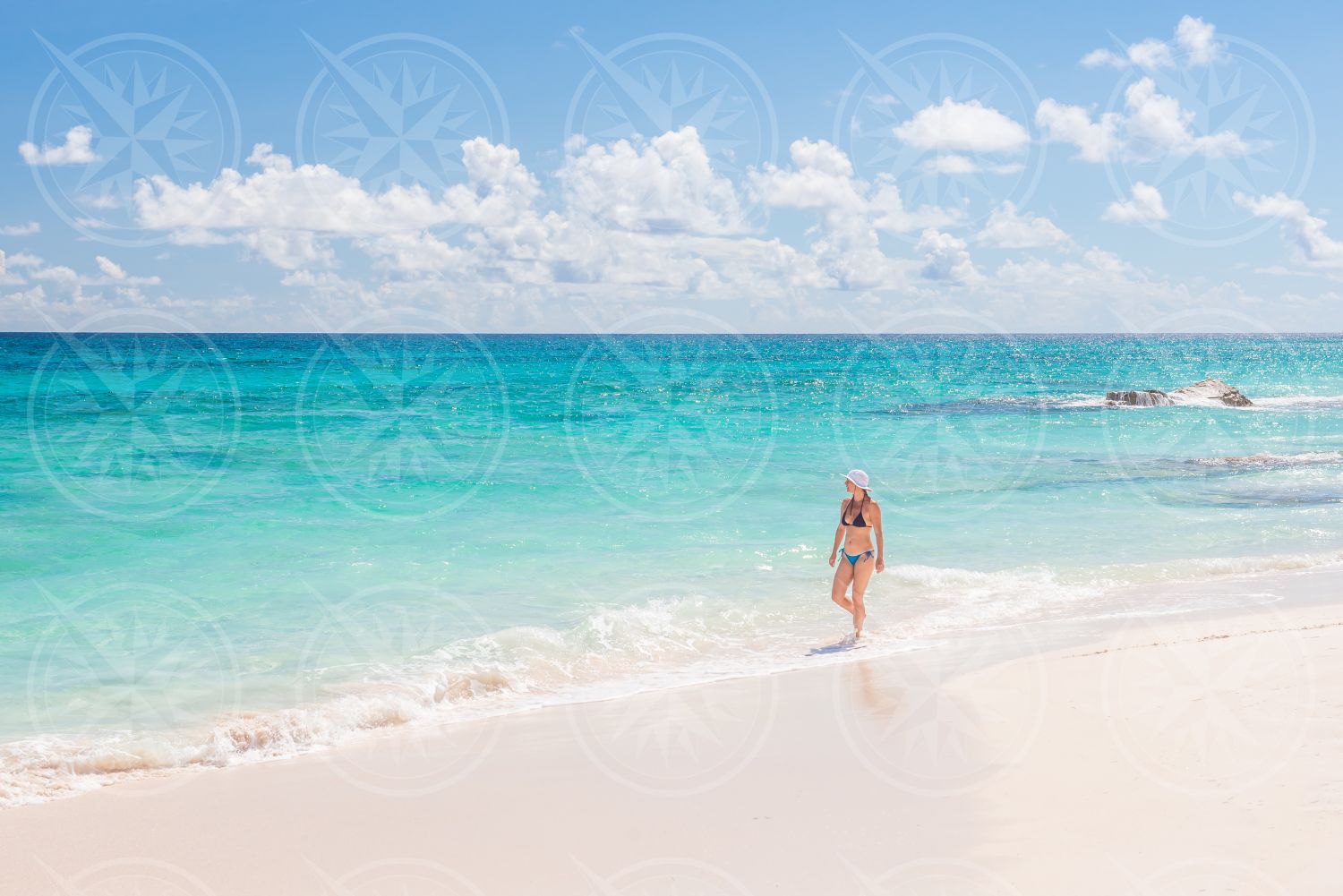 Woman in bikini on white sand beach