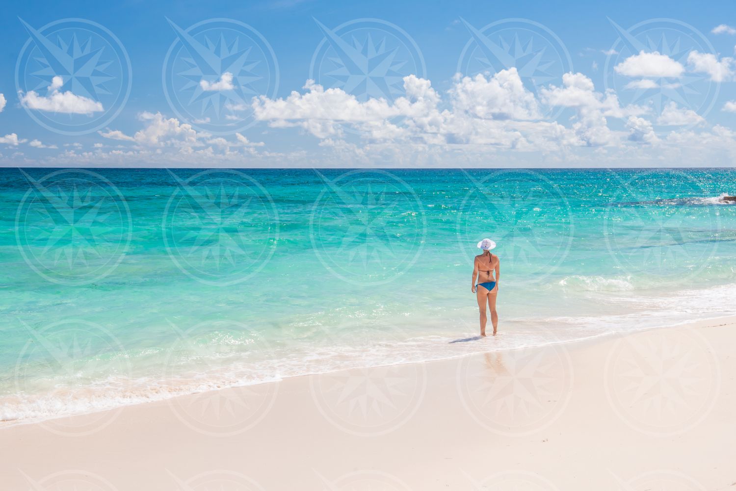 Woman in bikini on white sand beach