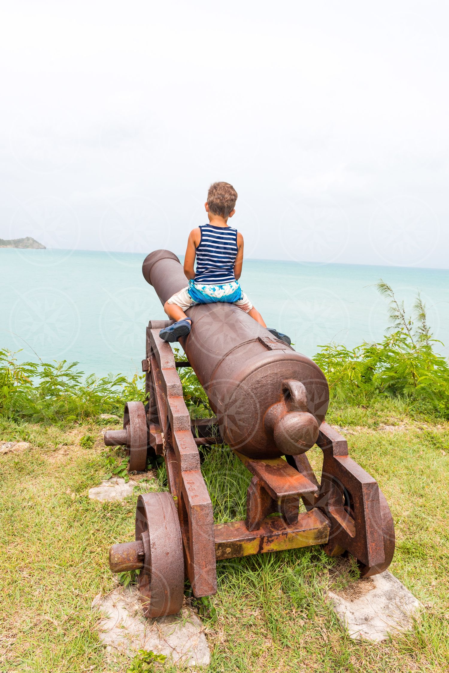 Boy on cannon at Fort James