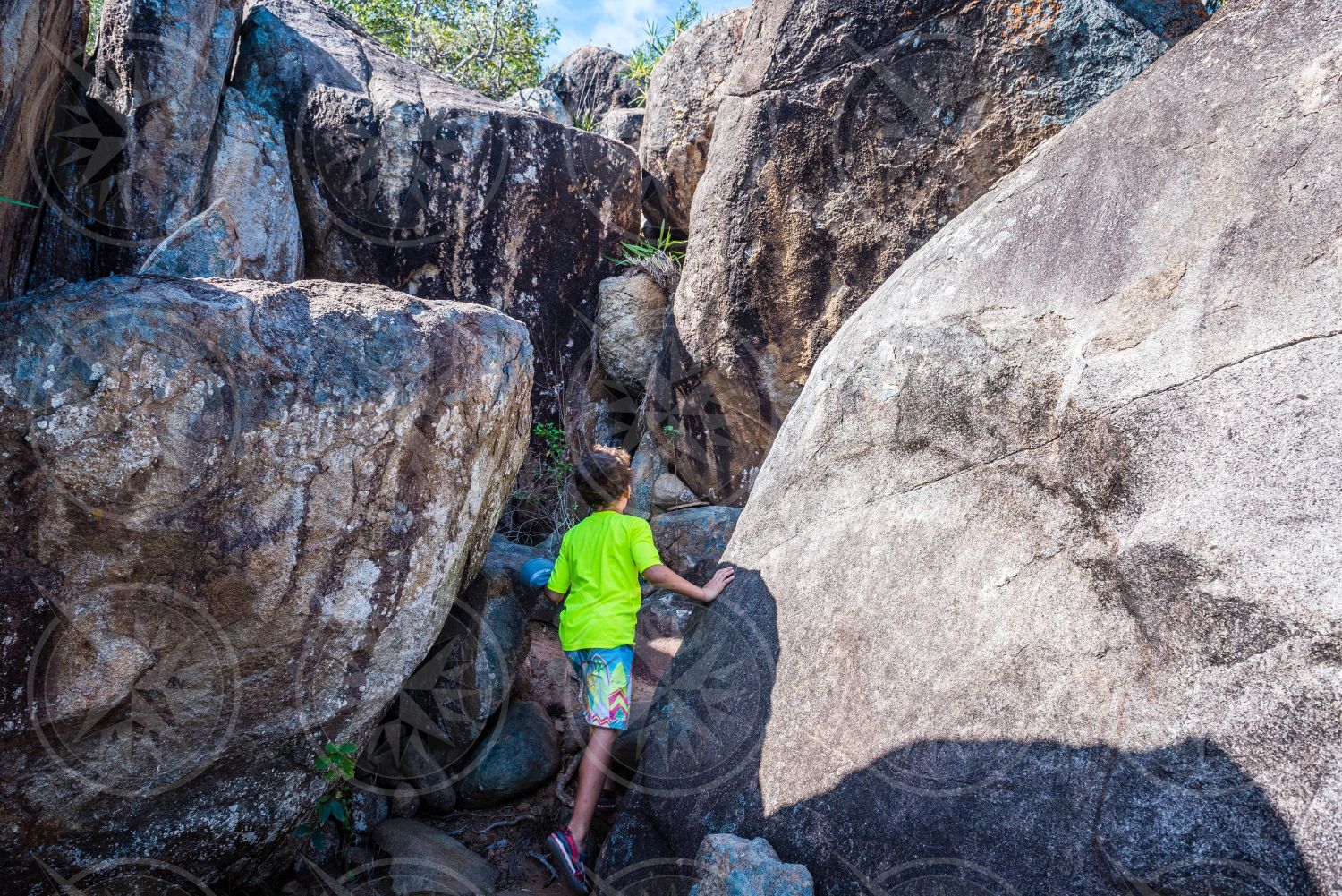 Young boy hiking through rocks