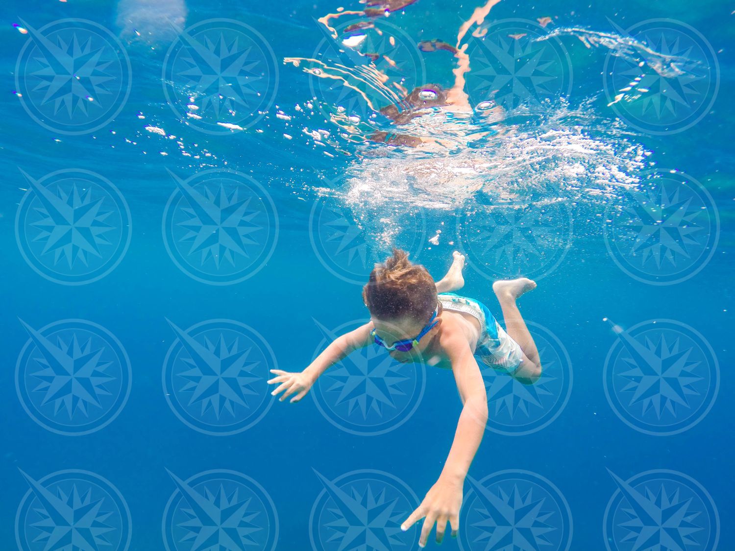 Young boy swimming underwater