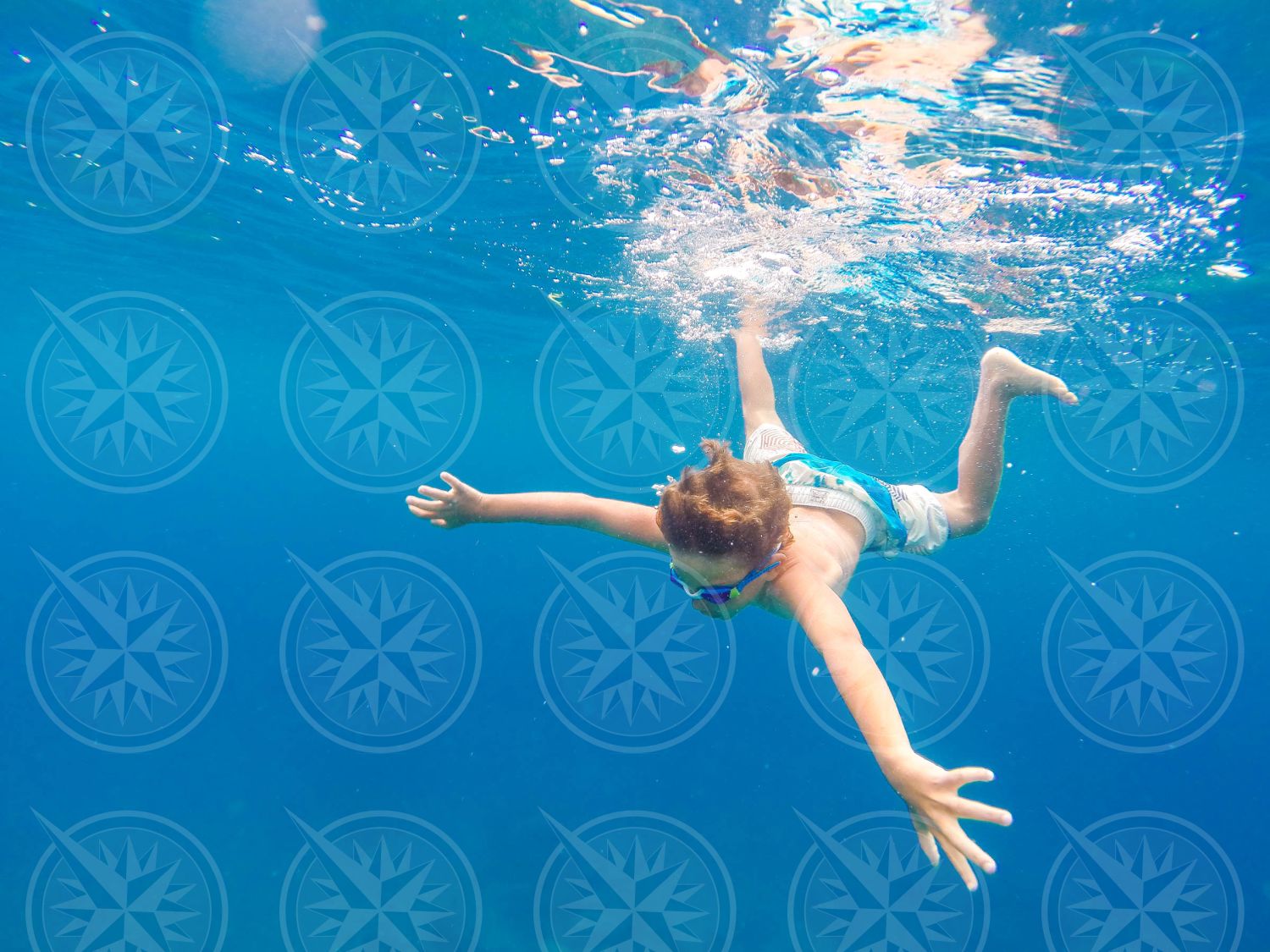 Young boy swimming underwater