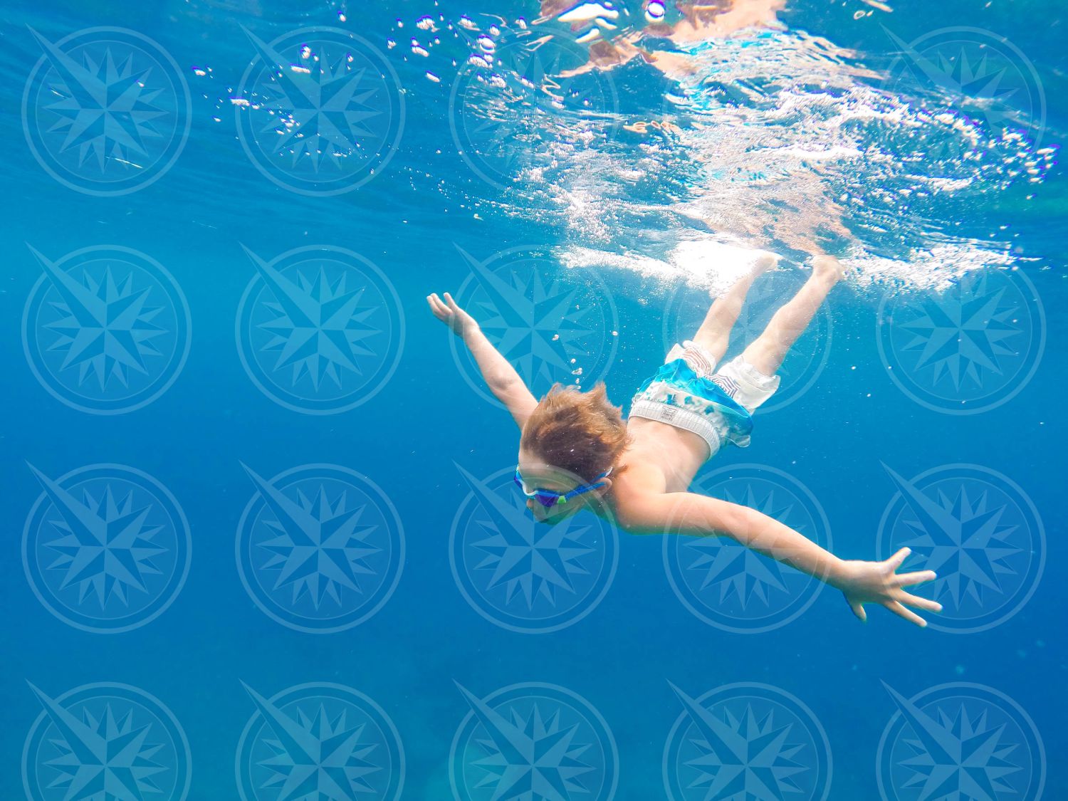 Young boy swimming underwater