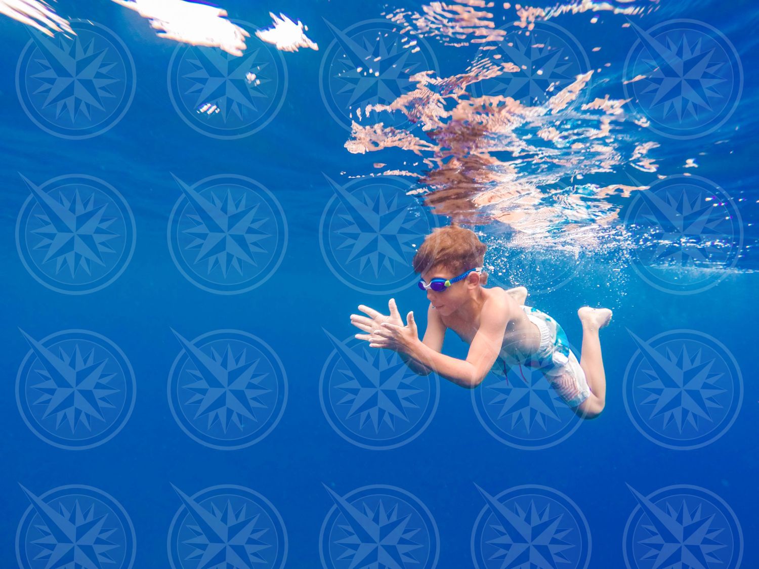 Young boy swimming underwater