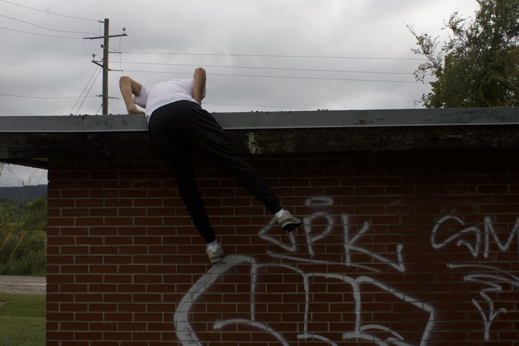 anthony climbing an abandoned house