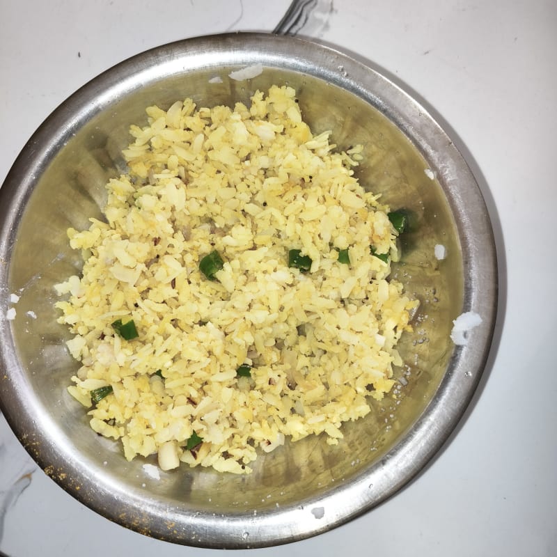 A steaming bowl of fluffy poha, cooked fresh each morning with hand‑picked peanu